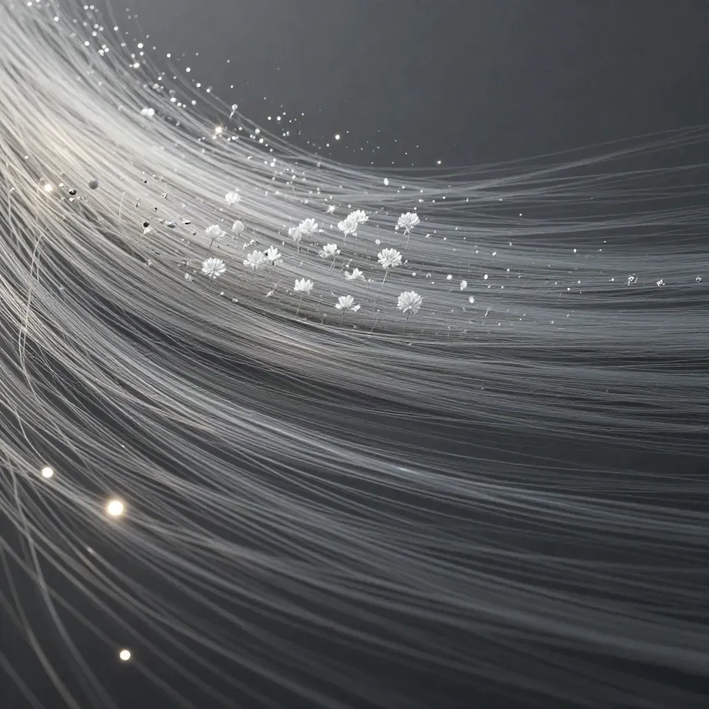 Silver filaments converge into a soft white bloom in dark graphite haze.